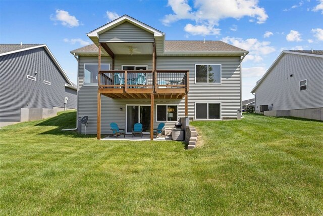 8 Pinnacle Ln, Tiffin, IA 52340 - rear view of property with a lawn, a patio area, a wooden deck, and a shingled roof