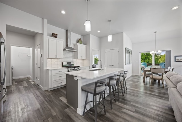 8 Pinnacle Ln, Tiffin, IA 52340 - kitchen with wall chimney range hood, appliances with stainless steel finishes, a sink, baseboards, and backsplash