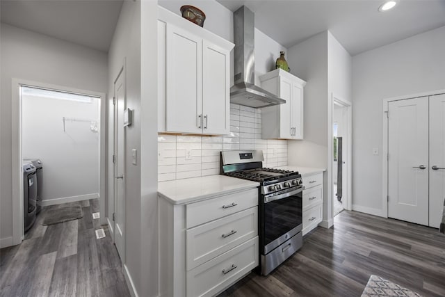 8 Pinnacle Ln, Tiffin, IA 52340 - kitchen featuring stainless steel gas range, wall chimney range hood, washing machine and clothes dryer, light countertops, and baseboards