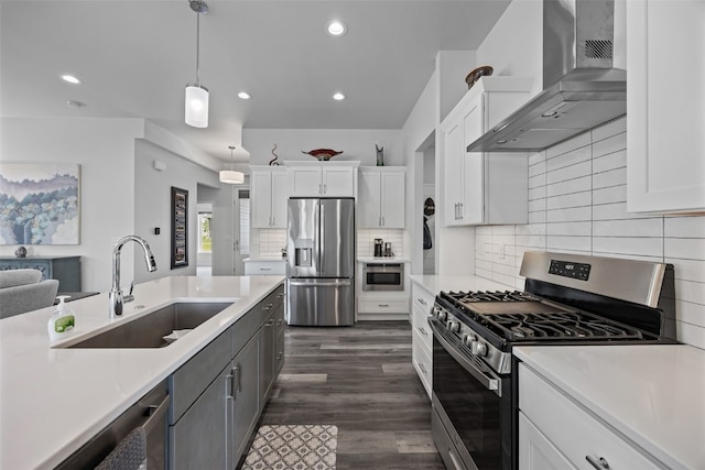 8 Pinnacle Ln, Tiffin, IA 52340 - kitchen with appliances with stainless steel finishes, wall chimney range hood, a sink, light countertops, and white cabinetry
