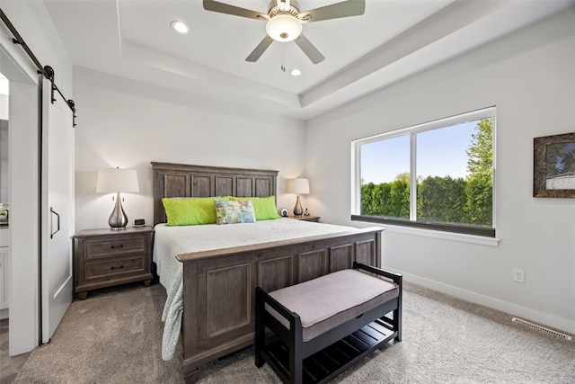 8 Pinnacle Ln, Tiffin, IA 52340 - carpeted bedroom with a barn door, recessed lighting, a raised ceiling, baseboards, and a ceiling fan