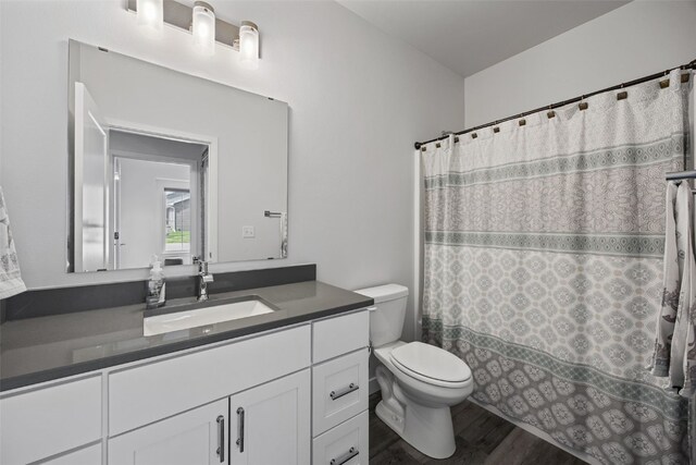 8 Pinnacle Ln, Tiffin, IA 52340 - full bathroom featuring toilet, vanity, and wood finished floors