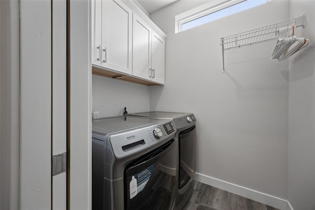 8 Pinnacle Ln, Tiffin, IA 52340 - laundry area featuring washing machine and clothes dryer, cabinet space, dark wood-type flooring, and baseboards