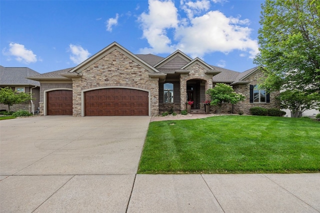 4355 Par Cir, Marion, IA 52302 - view of front facade featuring an attached garage, a front yard, concrete driveway, and stone siding