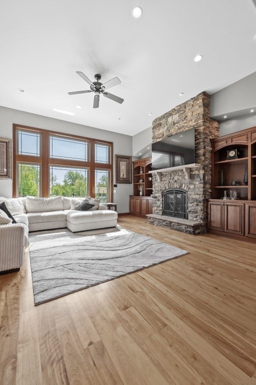 4355 Par Cir, Marion, IA 52302 - living room with wood finished floors, ceiling fan, recessed lighting, and a fireplace