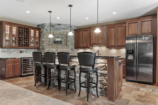 4355 Par Cir, Marion, IA 52302 - kitchen with stainless steel refrigerator with ice dispenser, wine cooler, a kitchen breakfast bar, decorative backsplash, and recessed lighting