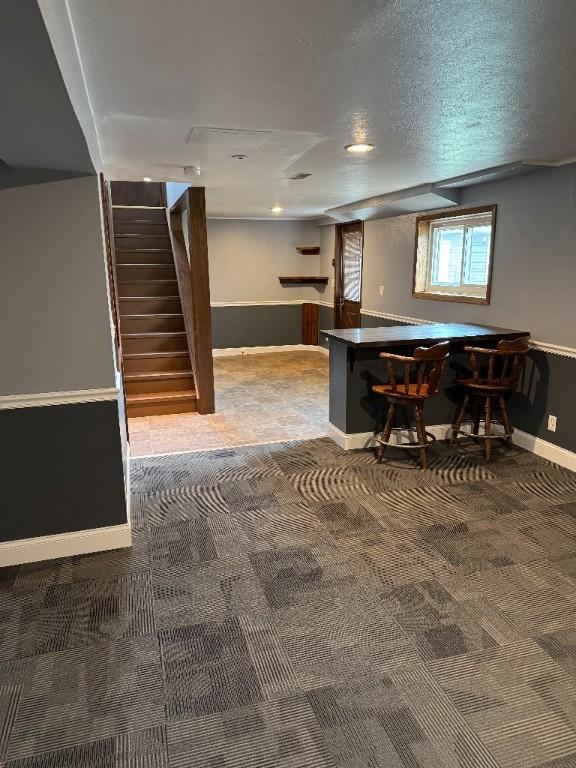 3105 Wilson Ave SW, Cedar Rapids, IA 52404 - bar area with carpet floors, baseboards, and stairs