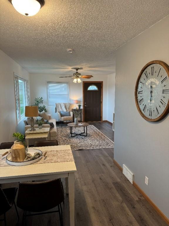 3105 Wilson Ave SW, Cedar Rapids, IA 52404 - living room with a textured ceiling, dark wood-style floors, a ceiling fan, and baseboards