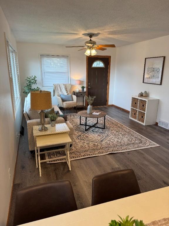 3105 Wilson Ave SW, Cedar Rapids, IA 52404 - living area with a ceiling fan, wood finished floors, baseboards, and a textured ceiling