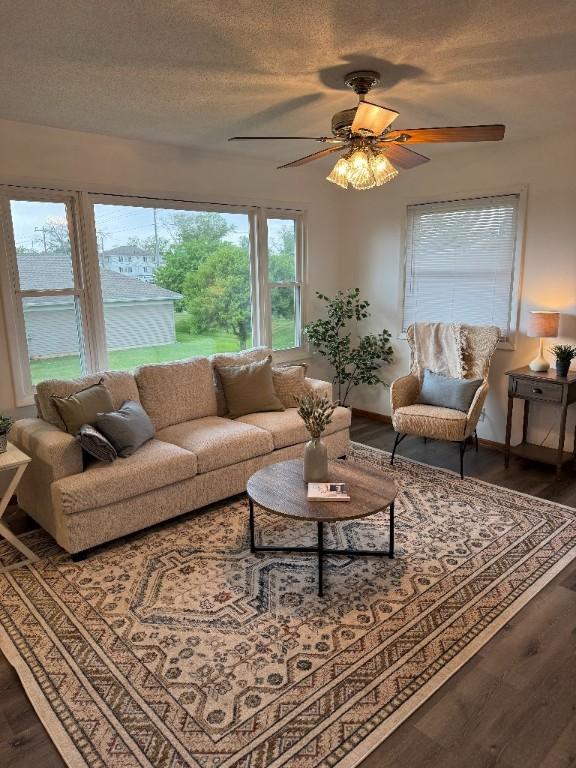 3105 Wilson Ave SW, Cedar Rapids, IA 52404 - living area with wood finished floors, a ceiling fan, a textured ceiling, and baseboards