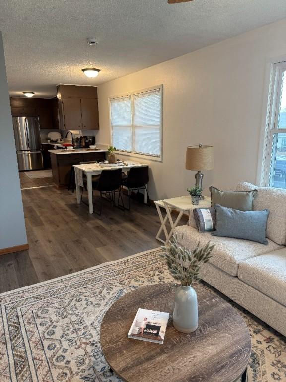 3105 Wilson Ave SW, Cedar Rapids, IA 52404 - living room featuring wood finished floors and a textured ceiling