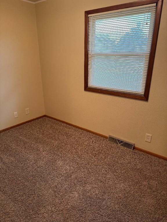 3105 Wilson Ave SW, Cedar Rapids, IA 52404 - spare room featuring carpet flooring and baseboards