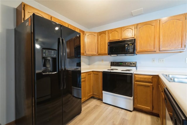 3035 English Glen Ct Unit D7, Marion, IA 52302 - kitchen with black appliances, light wood-style floors, light countertops, and a sink