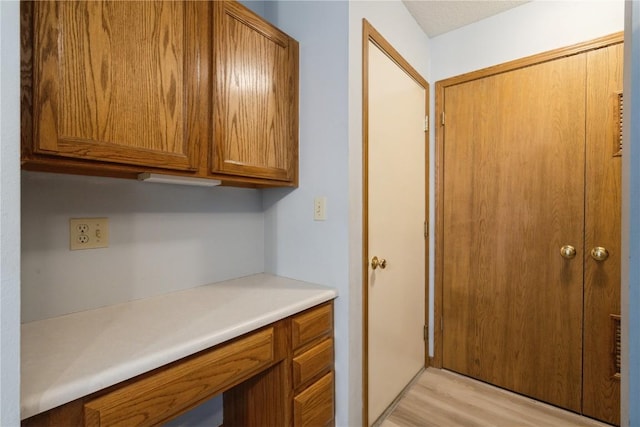 3035 English Glen Ct Unit D7, Marion, IA 52302 - kitchen with brown cabinetry, light wood-type flooring, and light countertops
