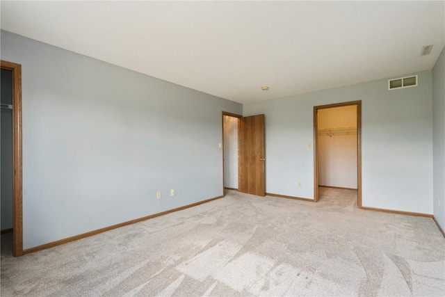 3035 English Glen Ct Unit D7, Marion, IA 52302 - unfurnished bedroom with a spacious closet, light carpet, baseboards, and a closet