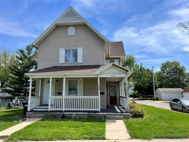 1213 11th St, Marion, IA 52302 - view of front of property with covered porch, a front lawn, and a shingled roof