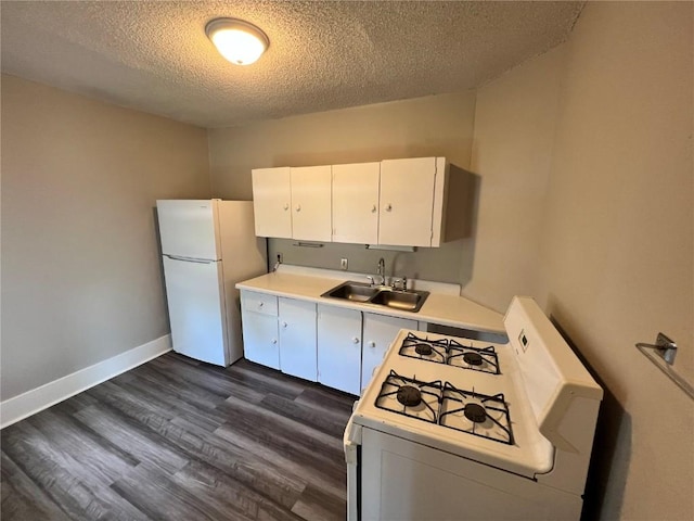1213 11th St, Marion, IA 52302 - kitchen featuring white appliances, a sink, a textured ceiling, light countertops, and dark wood-style floors