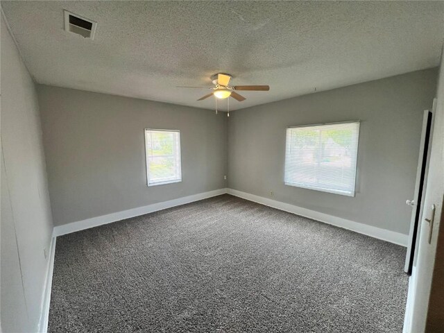 1213 11th St, Marion, IA 52302 - spare room with a ceiling fan, carpet floors, baseboards, and a textured ceiling
