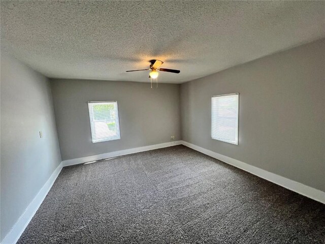 1213 11th St, Marion, IA 52302 - spare room featuring a ceiling fan, dark colored carpet, baseboards, and a textured ceiling