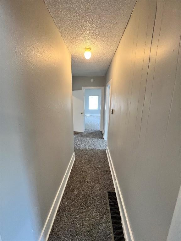 1213 11th St, Marion, IA 52302 - hallway with carpet floors, a textured ceiling, and baseboards