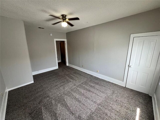 1213 11th St, Marion, IA 52302 - empty room featuring dark carpet, a ceiling fan, a textured ceiling, and baseboards