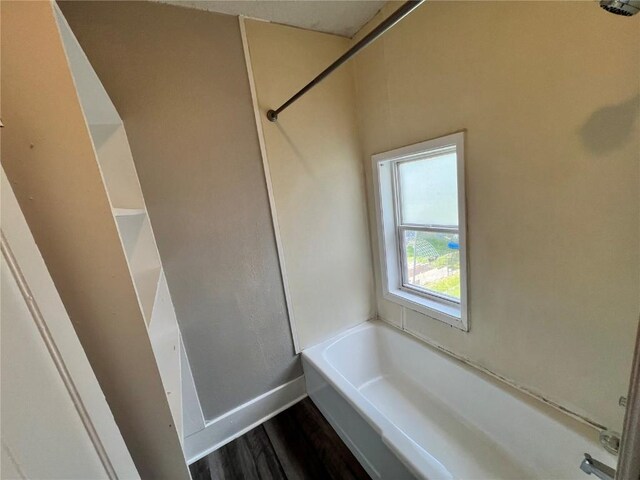 1213 11th St, Marion, IA 52302 - bathroom with a garden tub, wood finished floors, and baseboards