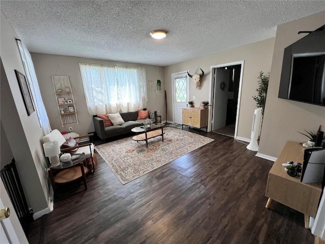 1213 11th St, Marion, IA 52302 - living room featuring dark wood-style flooring, a textured ceiling, and baseboards