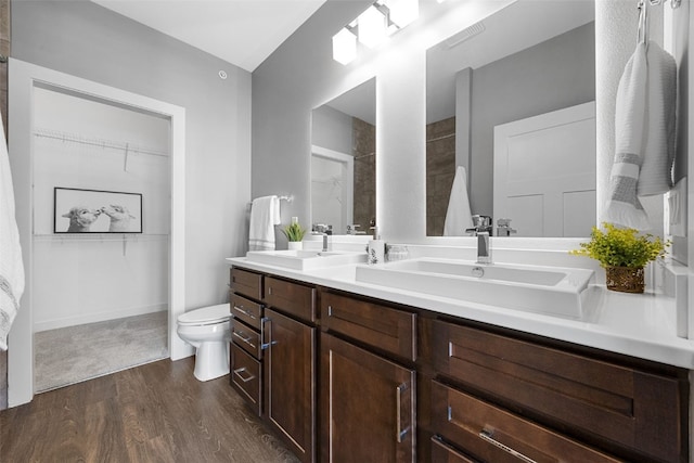 901 E 2nd Ave Unit 5, Coralville, IA 52241 - bathroom featuring wood finished floors, toilet, a spacious closet, and double vanity