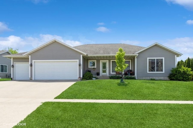 5305 Prairie Ridge Ave, Marion, IA 52302 - ranch-style house with a garage, driveway, a front yard, and a porch