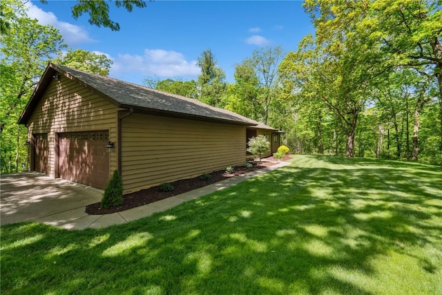 1445 NE Butternut Ln, Swisher, IA 52338 - view of side of home featuring a garage, a lawn, and roof with shingles