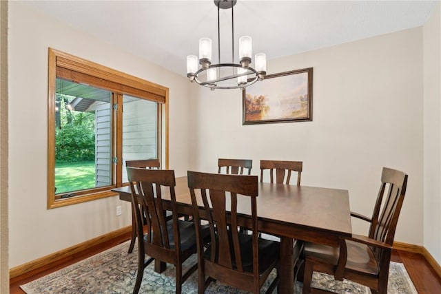 1445 NE Butternut Ln, Swisher, IA 52338 - dining space featuring a chandelier, wood finished floors, and baseboards