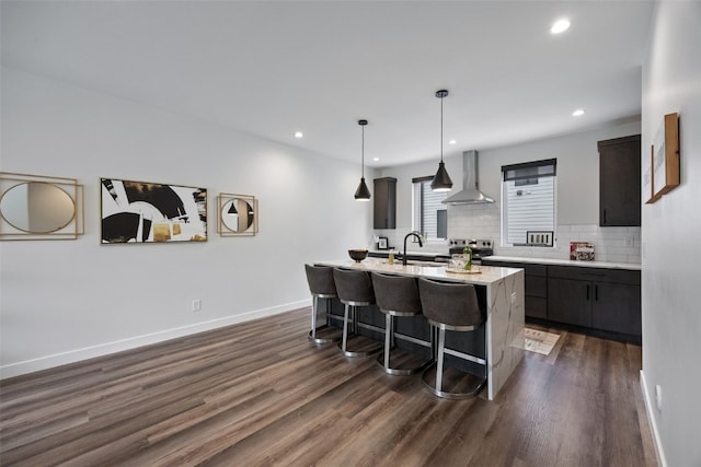 830 Newton Rd Unit 4, Iowa City, IA 52246 - kitchen featuring wall chimney exhaust hood, electric range, a kitchen bar, a sink, and dark wood finished floors