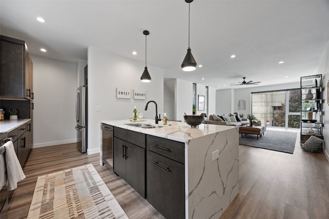 830 Newton Rd Unit 4, Iowa City, IA 52246 - kitchen featuring stainless steel appliances, a sink, light wood finished floors, a center island with sink, and recessed lighting