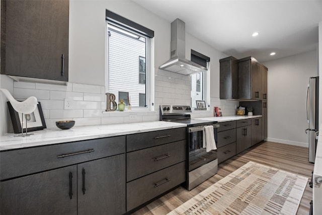 830 Newton Rd Unit 4, Iowa City, IA 52246 - kitchen featuring appliances with stainless steel finishes, wall chimney range hood, plenty of natural light, tasteful backsplash, and recessed lighting