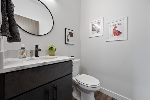 830 Newton Rd Unit 4, Iowa City, IA 52246 - bathroom with wood finished floors, toilet, vanity, and baseboards