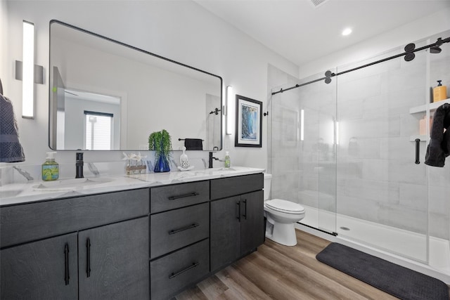 830 Newton Rd Unit 4, Iowa City, IA 52246 - full bath featuring a shower stall, wood finished floors, double vanity, and toilet