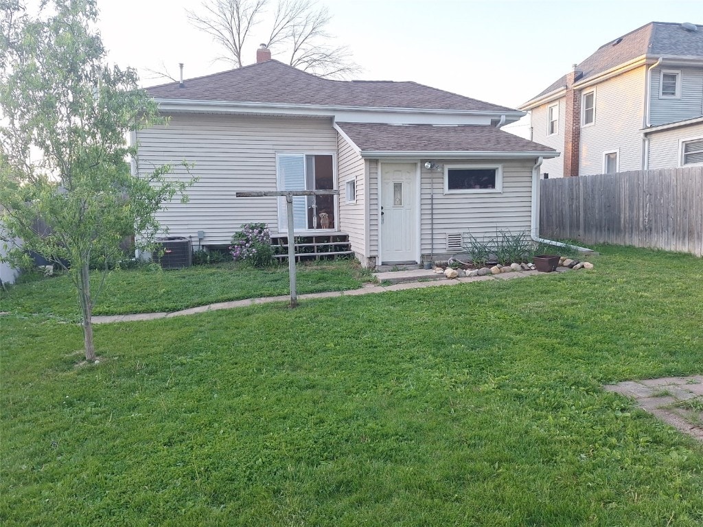 501 9th Ave, Marion, IA 52302 - rear view of house with a shingled roof and cooling unit