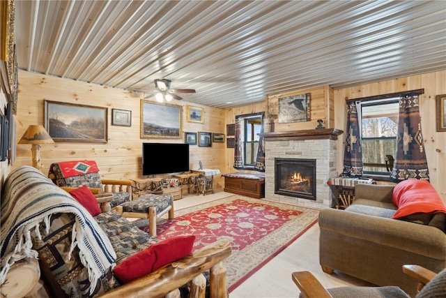 2527 61st St Ln Lot 1, Vinton, IA 52349 - living area with wooden walls, a fireplace, and ceiling fan