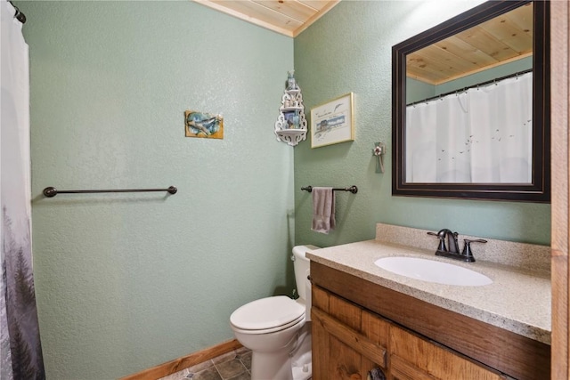 2527 61st St Ln Lot 1, Vinton, IA 52349 - bathroom featuring toilet, vanity, a textured wall, baseboards, and tile patterned floors