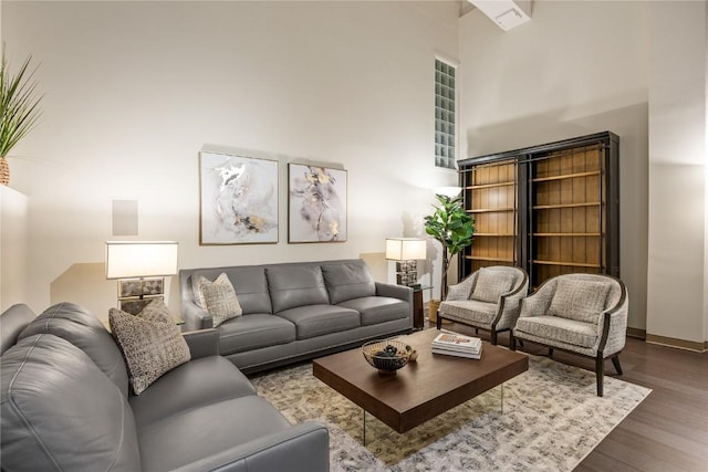 905 3rd St SE Unit 111, Cedar Rapids, IA 52401 - living room with dark wood-type flooring, a high ceiling, and baseboards