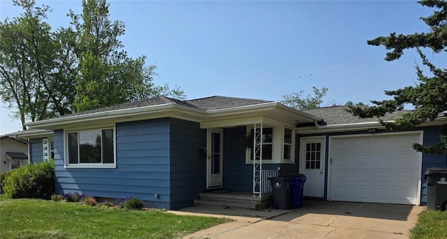 2222 Evergreen St NE, Cedar Rapids, IA 52402 - ranch-style home with a garage, driveway, a shingled roof, and a front lawn