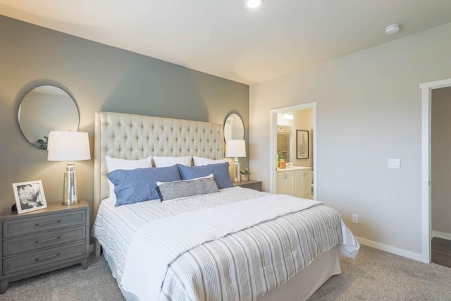 704 Magnolia Way, Tiffin, IA 52340 - carpeted bedroom with baseboards and ensuite bathroom
