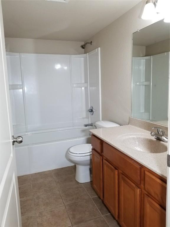 200 Grandview Ct Unit 204, Iowa City, IA 52246 - full bathroom with toilet, vanity, tile patterned flooring, and washtub / shower combination