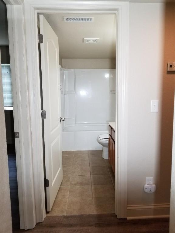 200 Grandview Ct Unit 204, Iowa City, IA 52246 - bathroom featuring vanity, tile patterned floors, toilet, and bathing tub / shower combination