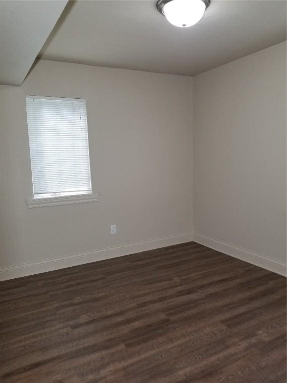 200 Grandview Ct Unit 204, Iowa City, IA 52246 - spare room featuring baseboards and dark wood-style floors