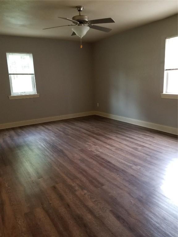 200 Grandview Ct Unit 204, Iowa City, IA 52246 - unfurnished room with dark wood finished floors, a ceiling fan, and baseboards