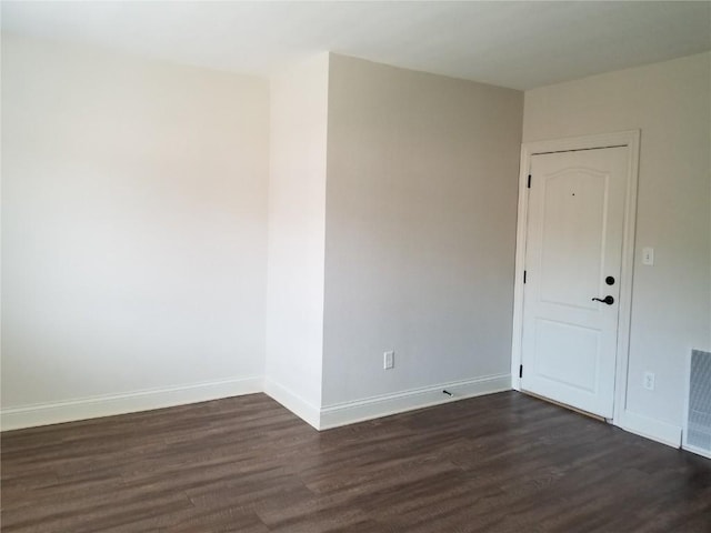 100 Granview Ct Unit 126, Iowa City, IA 52246 - unfurnished room with dark wood-style floors and baseboards