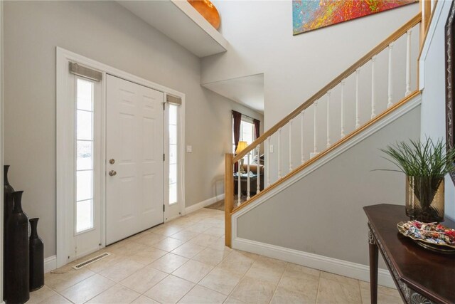 3010 Newcastle Rd, Marion, IA 52302 - foyer featuring stairs, baseboards, and tile patterned floors