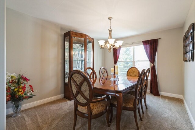 3010 Newcastle Rd, Marion, IA 52302 - dining area featuring a chandelier, carpet floors, and baseboards