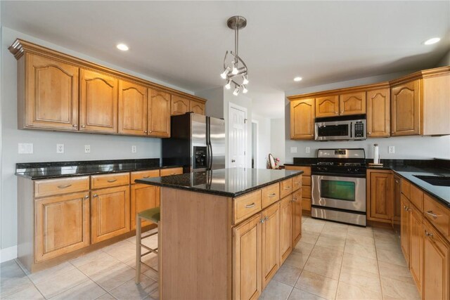 3010 Newcastle Rd, Marion, IA 52302 - kitchen with stainless steel appliances, a center island, light tile patterned floors, recessed lighting, and decorative light fixtures